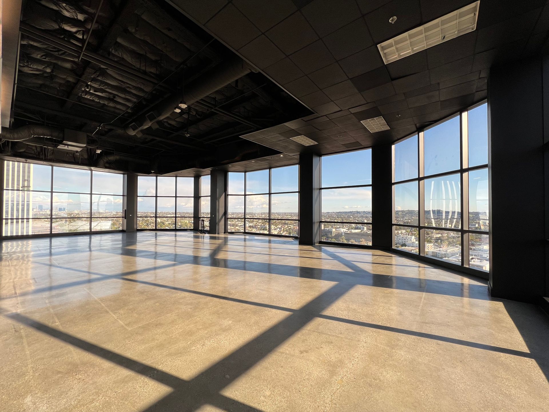 A large empty room with a lot of windows