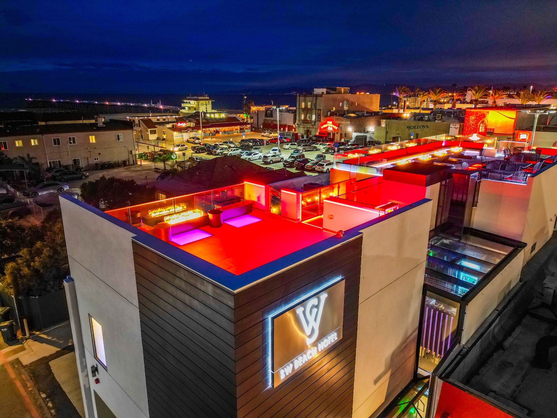 An aerial view of a building with a red roof
