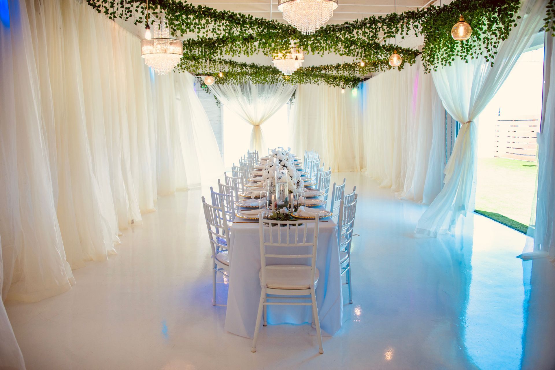 There is a long table and chairs in the middle of the room.