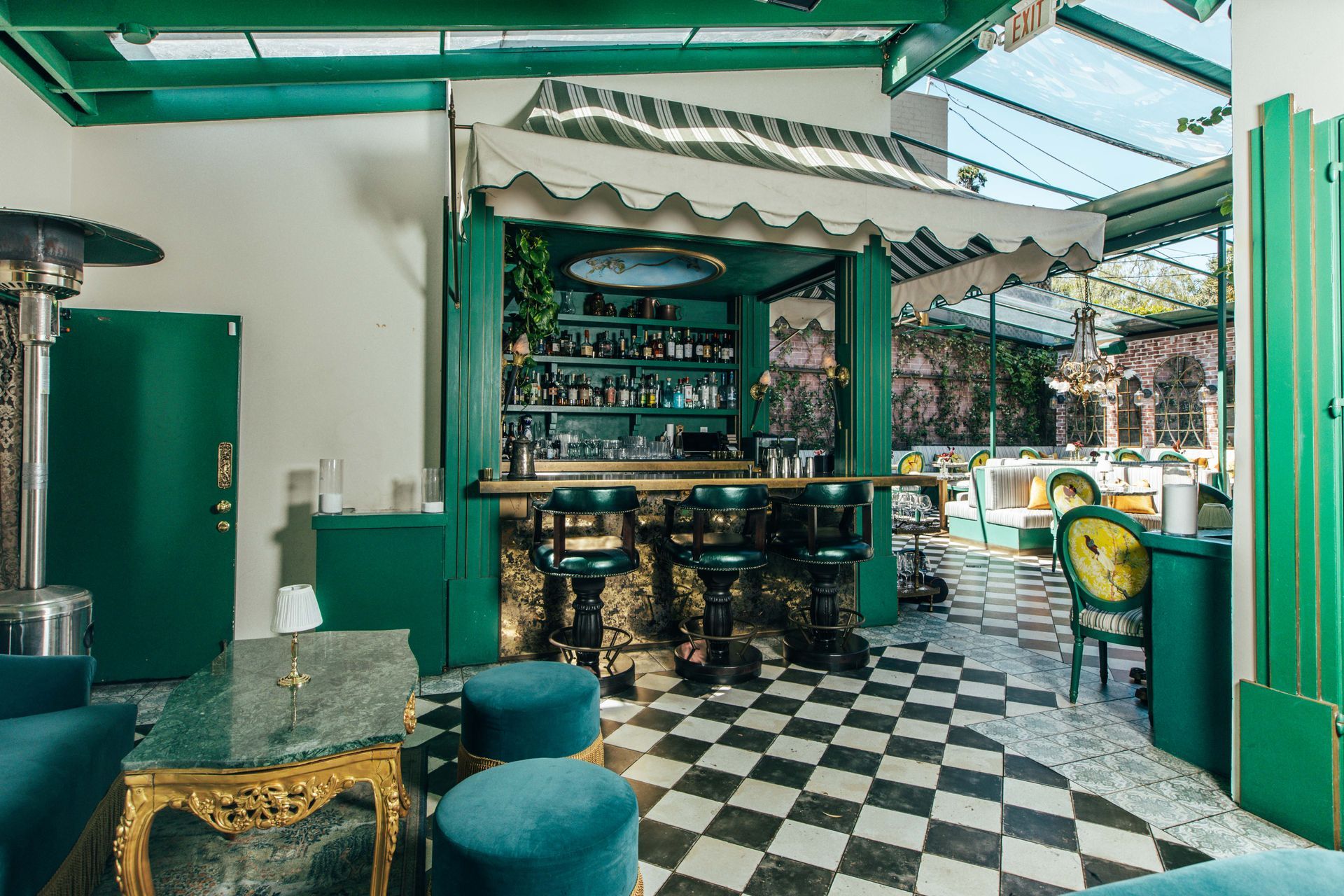 A restaurant with a checkered floor and a bar.