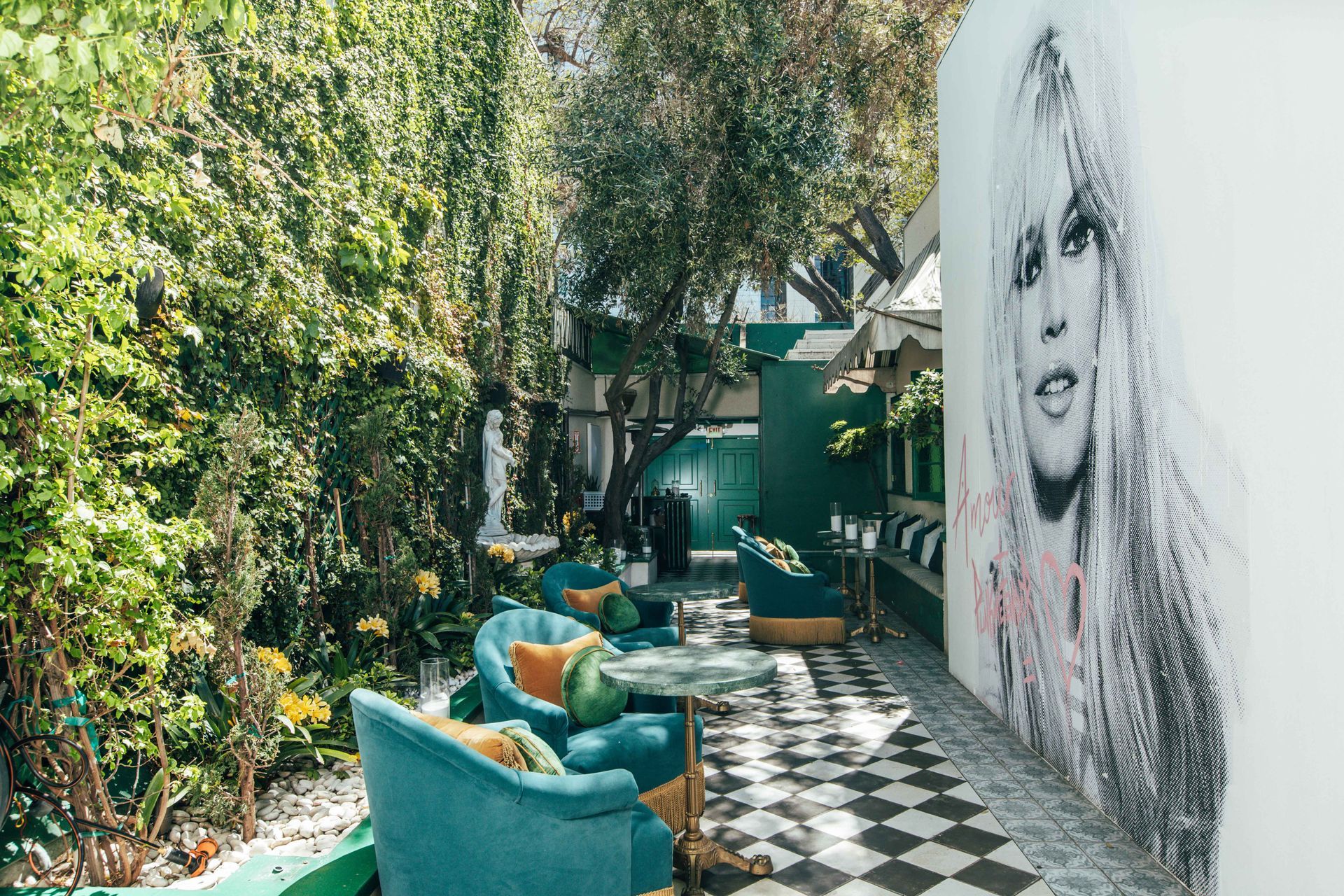 There is a painting of a woman on the wall of a building.