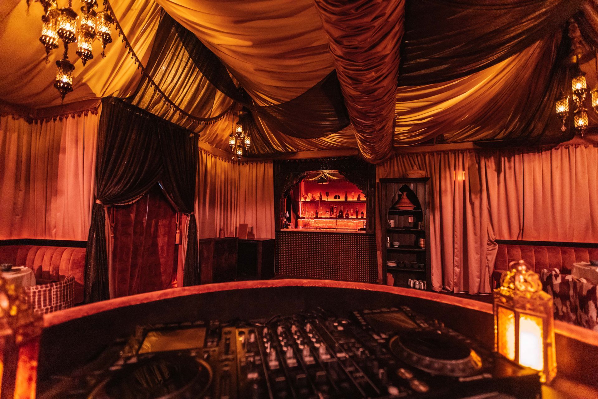 There is a dj booth in the middle of the room.