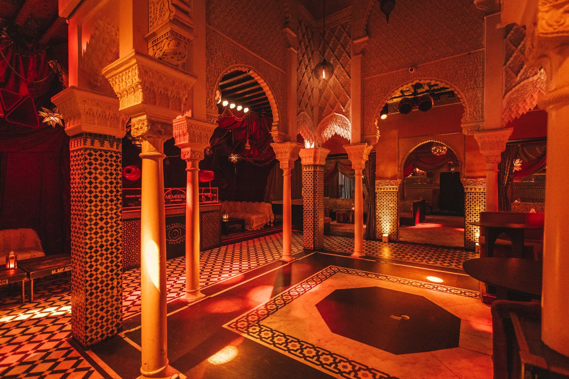 A room with arches and columns and a circular floor