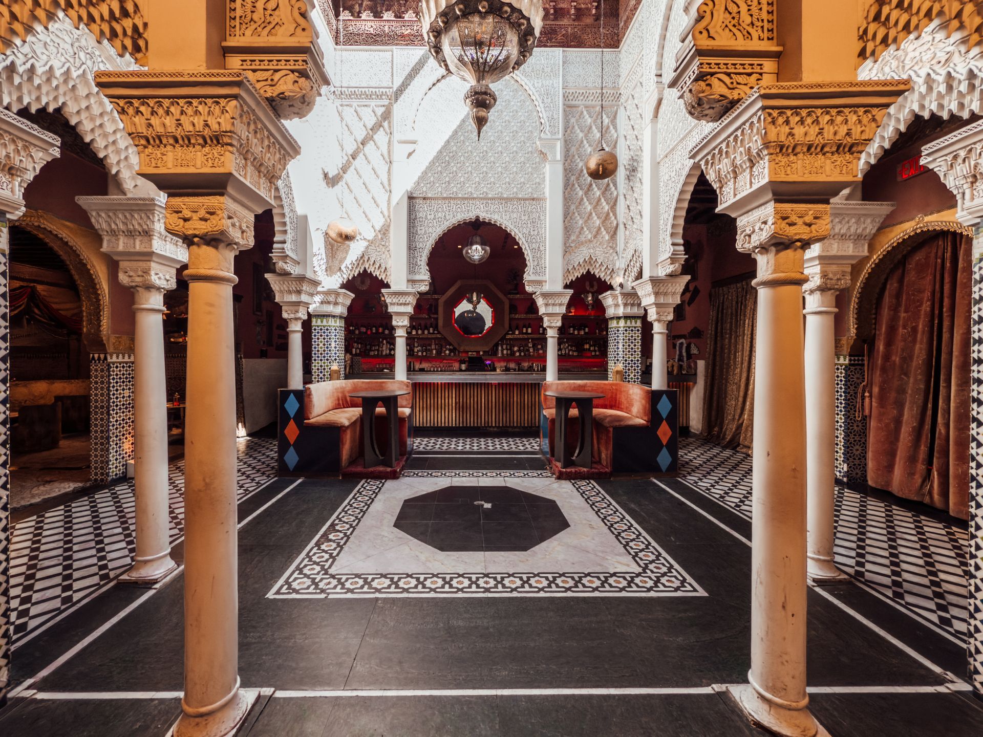 A room with columns and arches in a very ornate building.