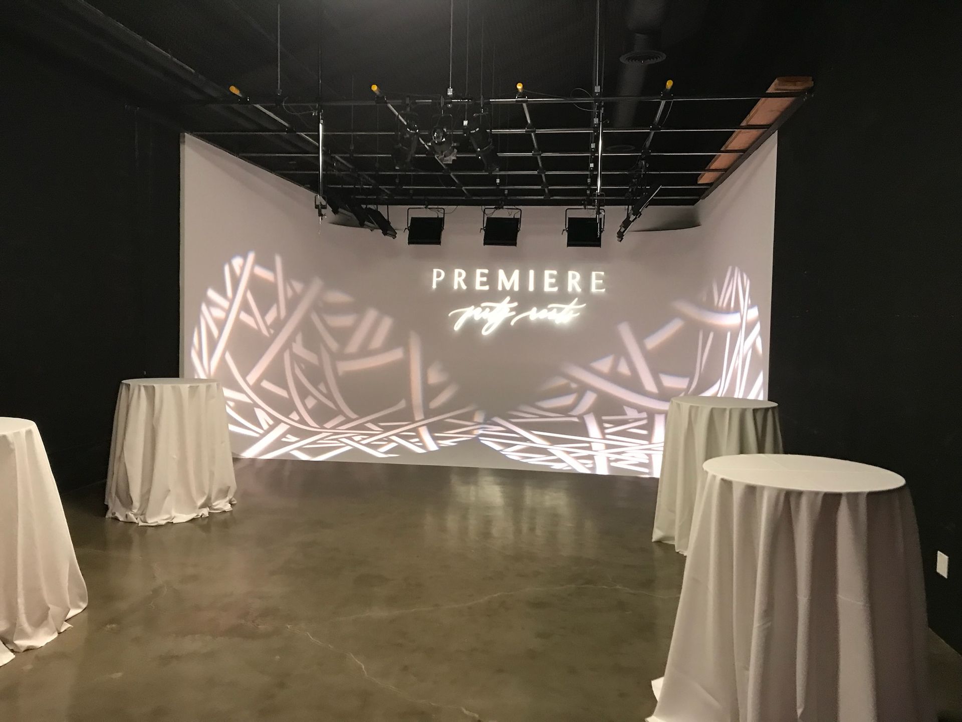 A modern event space with a projection screen reading 
