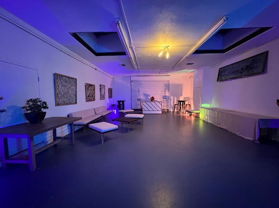 A large room with a lot of furniture and a blue light on the ceiling.