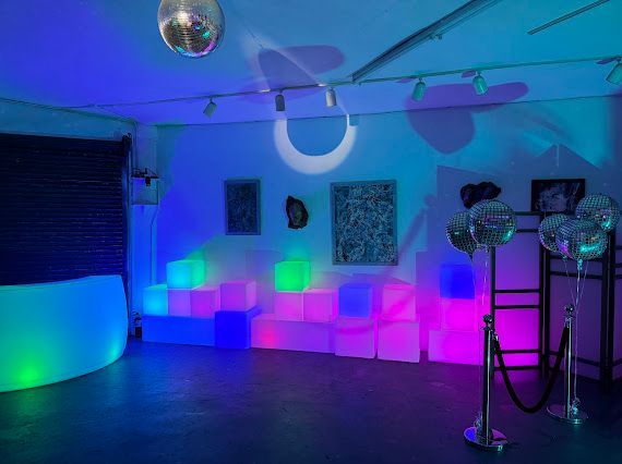 A room filled with lots of lights and balloons.