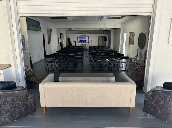 A large room with a couch and chairs in it