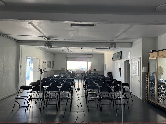 A large room filled with folding chairs and tables.