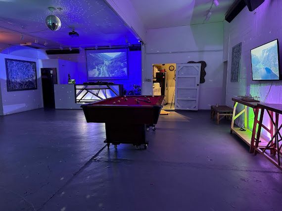 There is a pool table in the middle of the room.