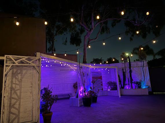 A white building with purple lights on it at night.