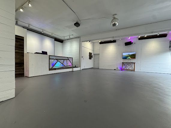 A large empty room with a gray floor and white walls.