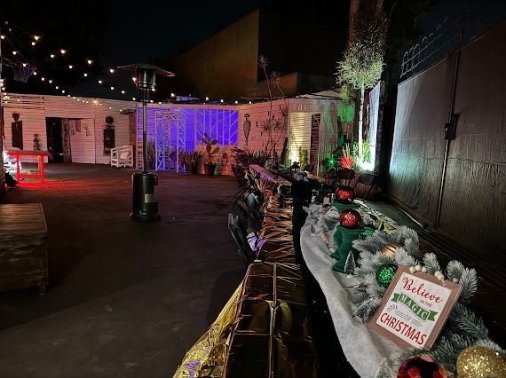 A patio decorated for christmas with a sign that says `` welcome to christmas ''.