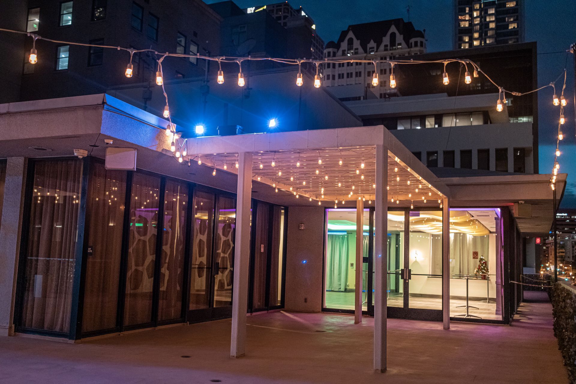 A building with a pergola and lights on it at night