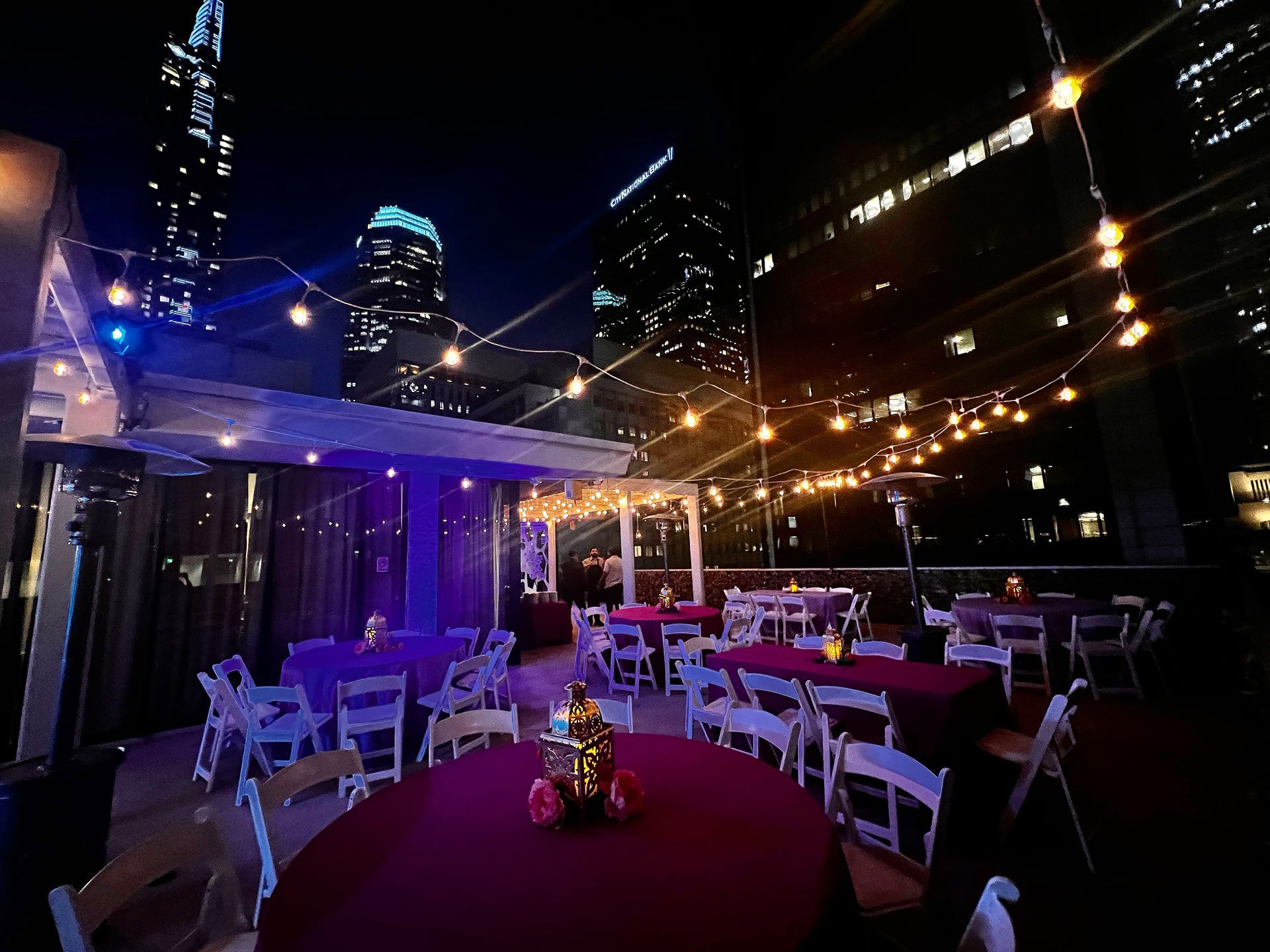 A patio with tables and chairs set up for a party at night.