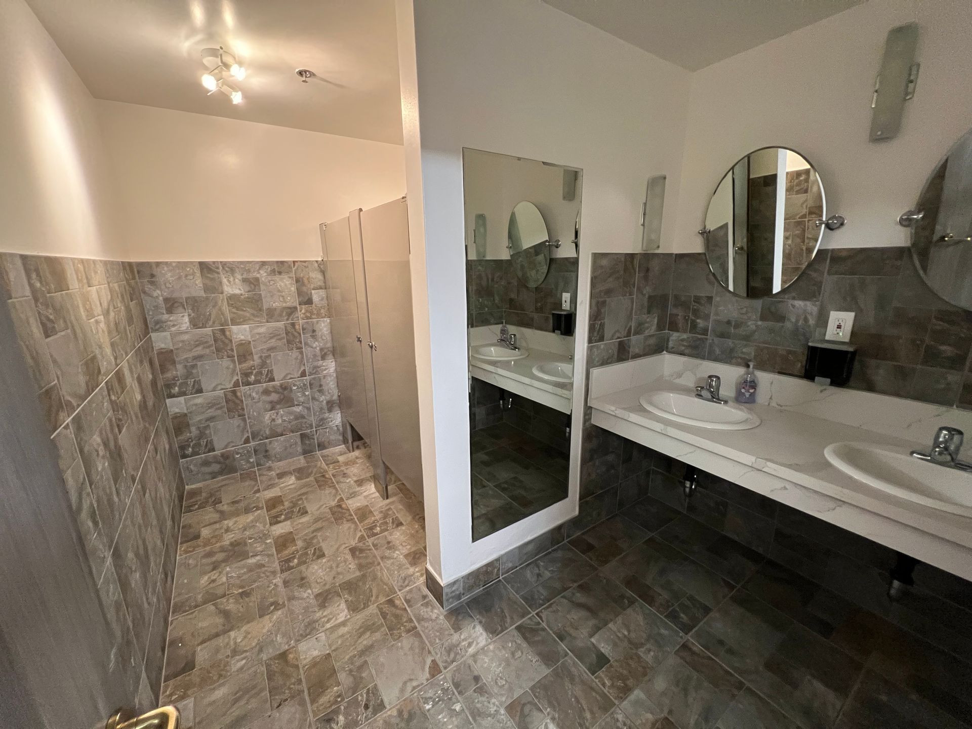 A bathroom with two sinks and two mirrors.
