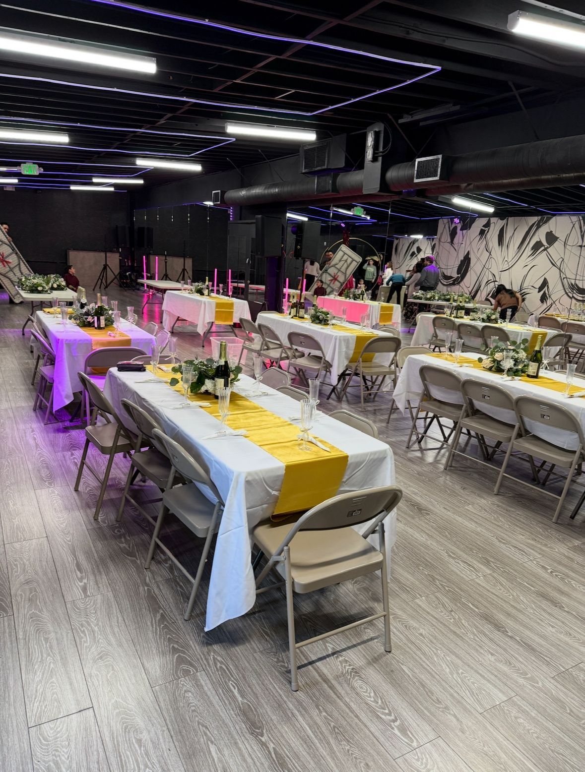 A large room filled with tables and chairs set up for a party.