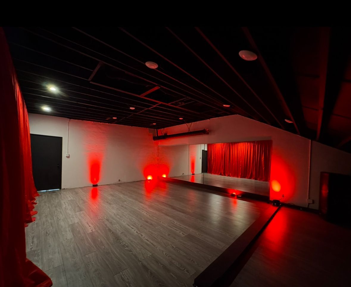 A large room with red lights on the walls and ceiling
