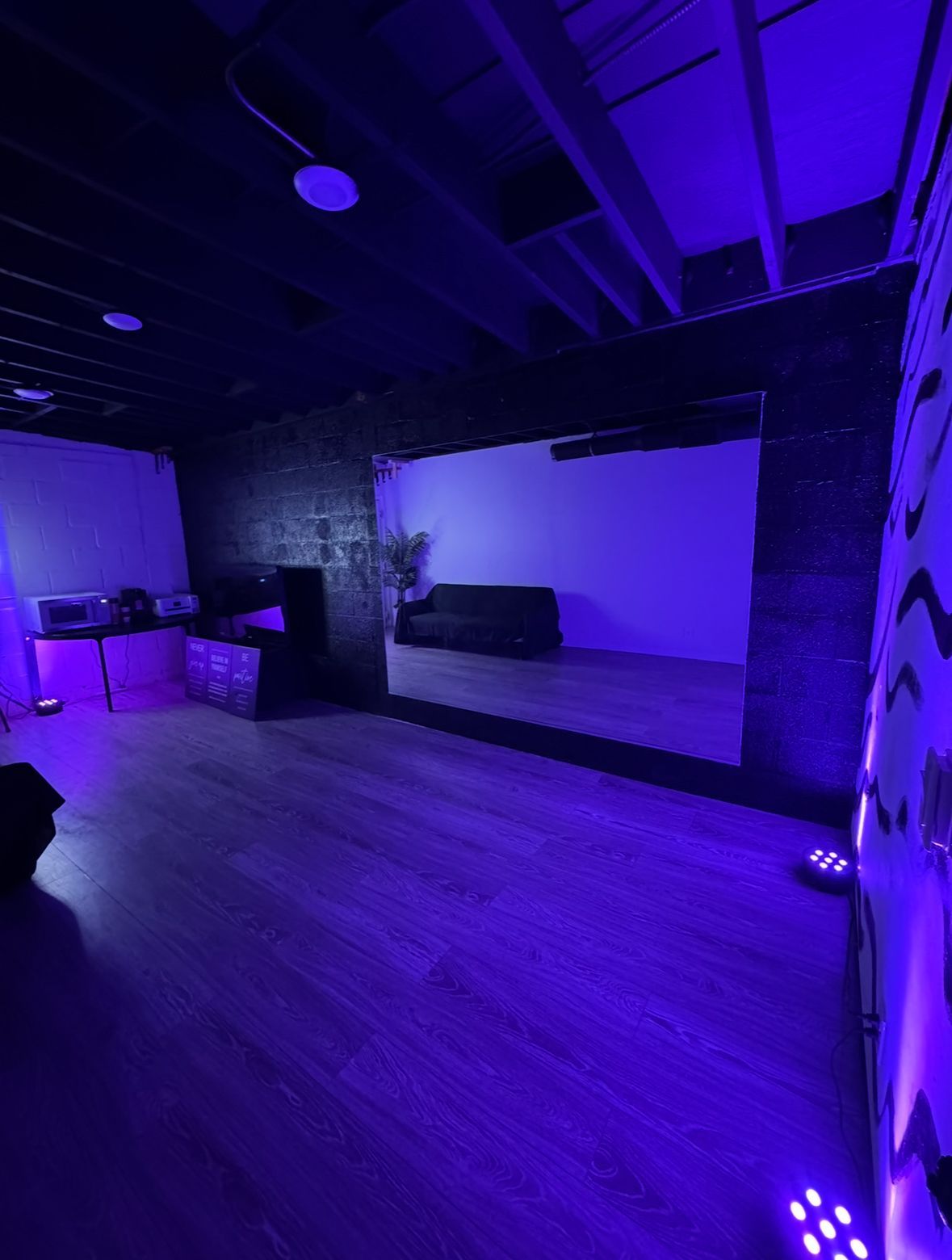 A large room with purple lights on the walls and ceiling.