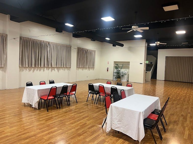 A large room with tables and chairs in it.