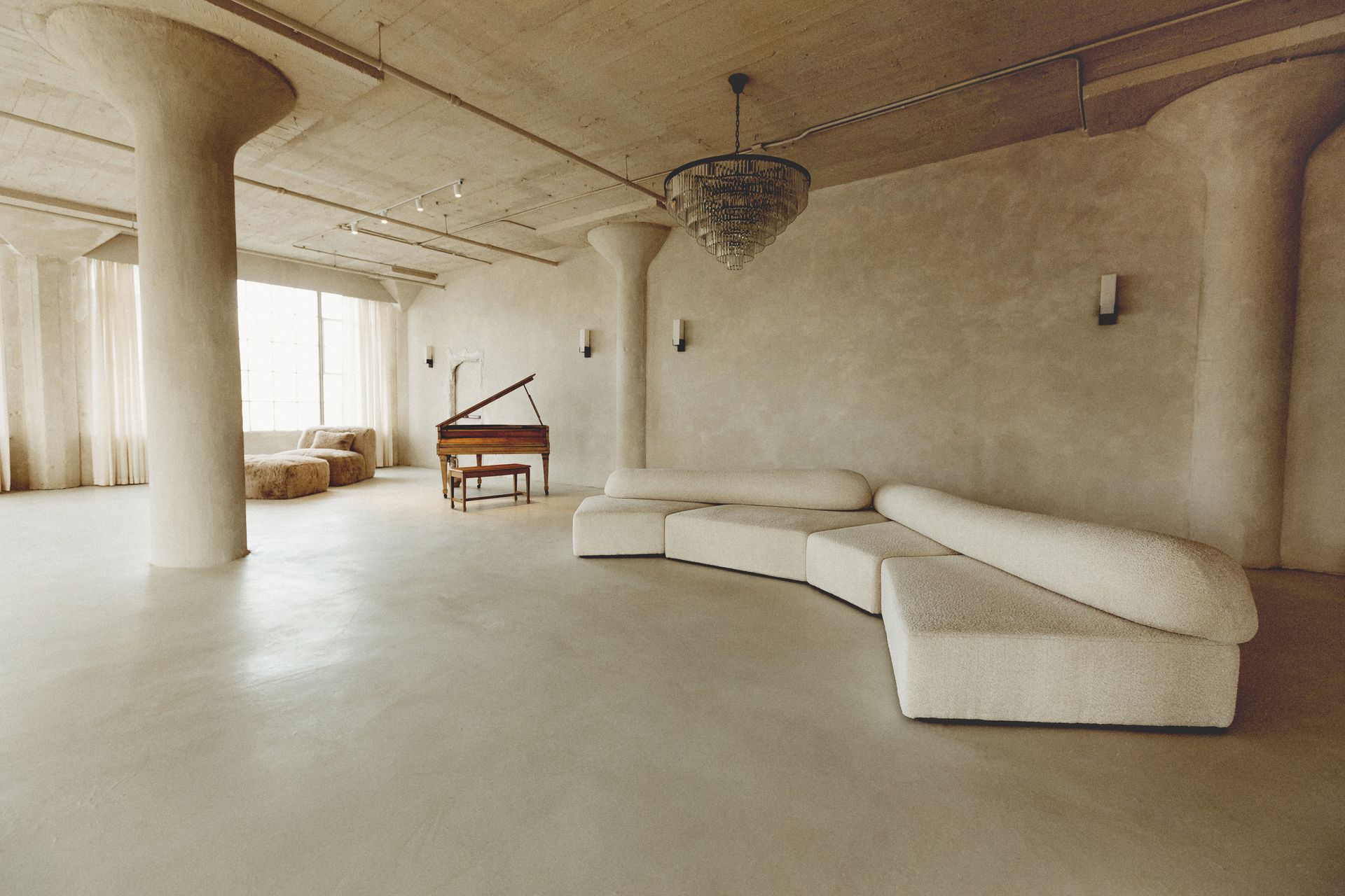 A large room with a piano and a couch
