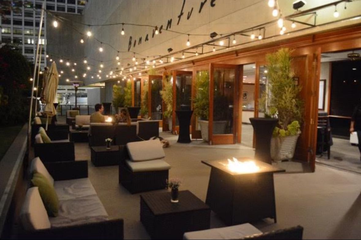 A patio area with a fire pit and a sign that says fireventure