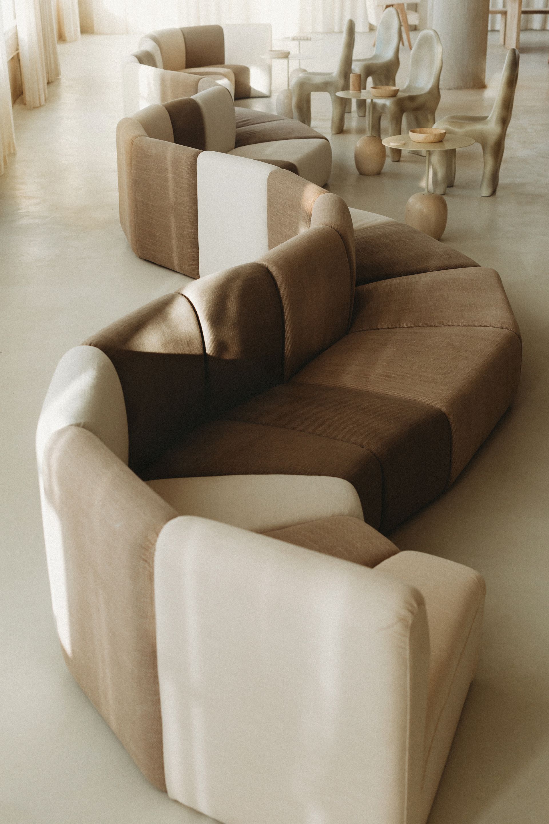 A room with a couch and chairs in it