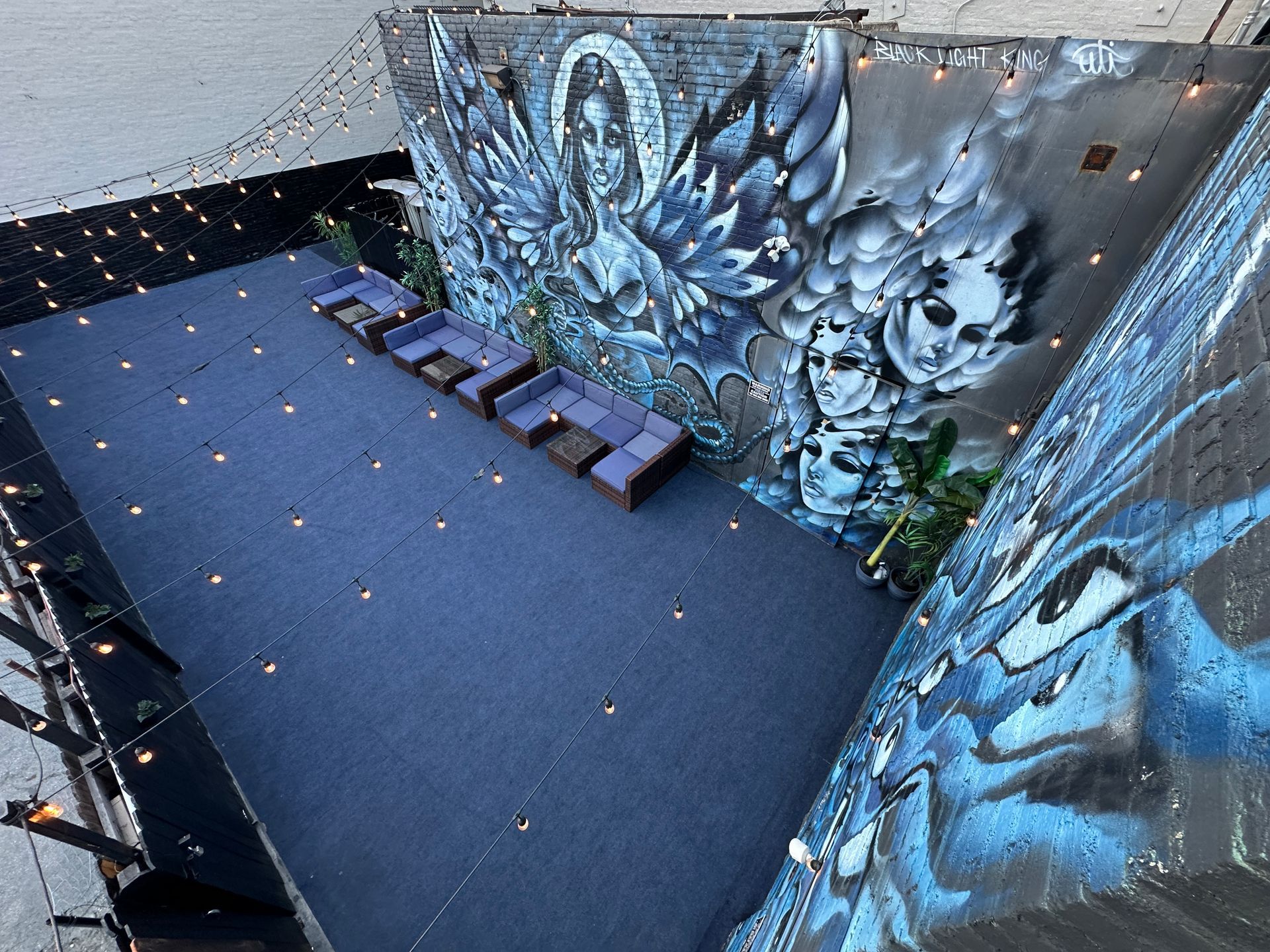 An aerial view of a stage with a mural on the wall.