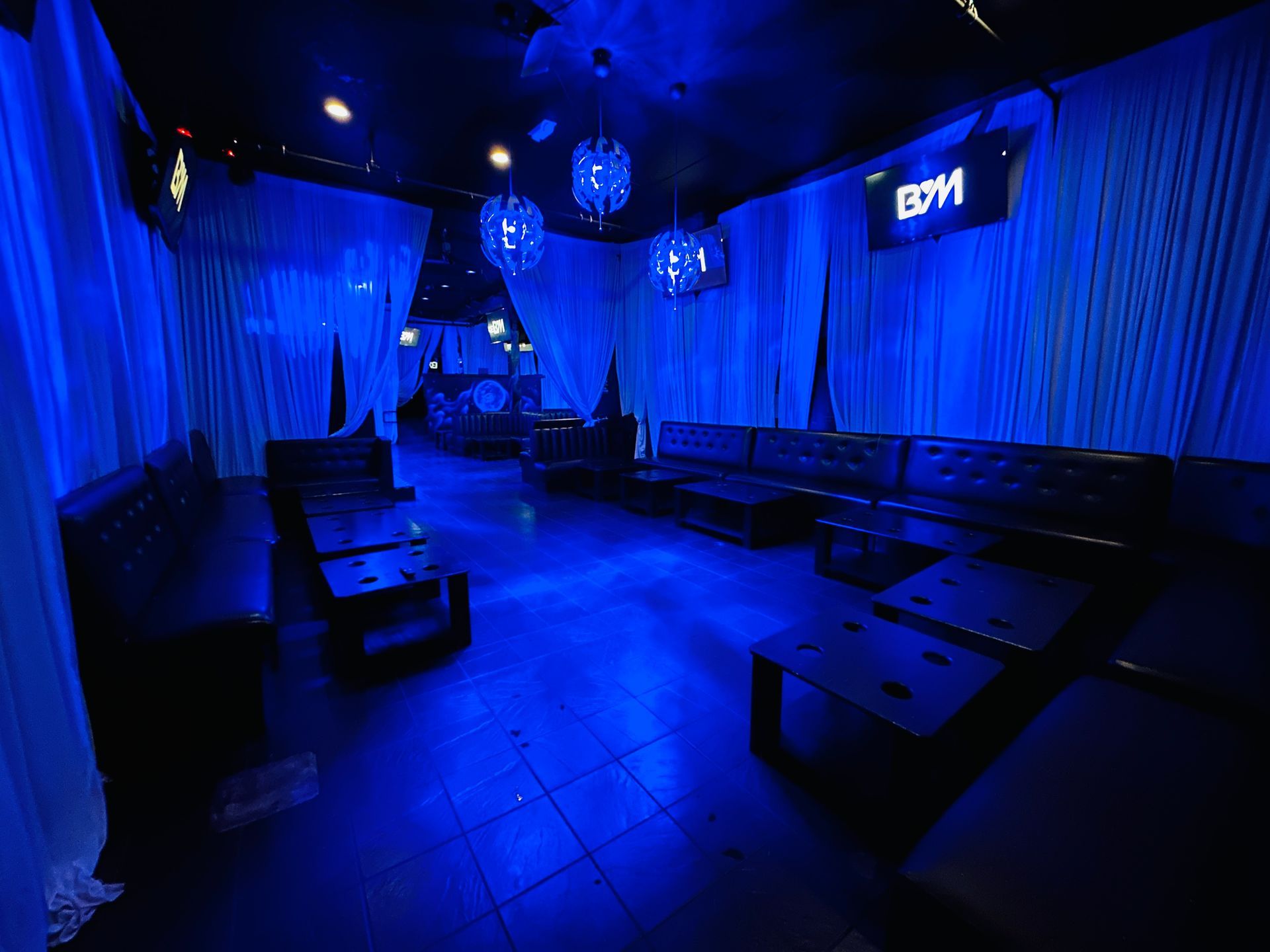 A large room with blue lights on the walls and ceiling.