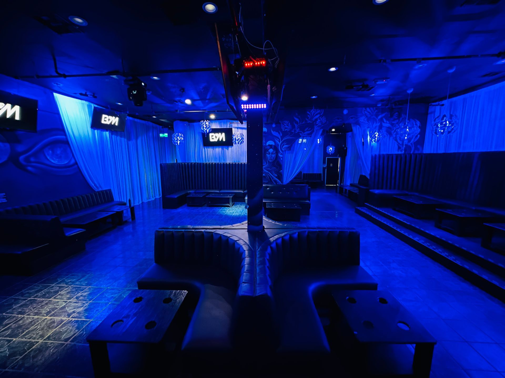 A room with blue lights and a sign that says bpm