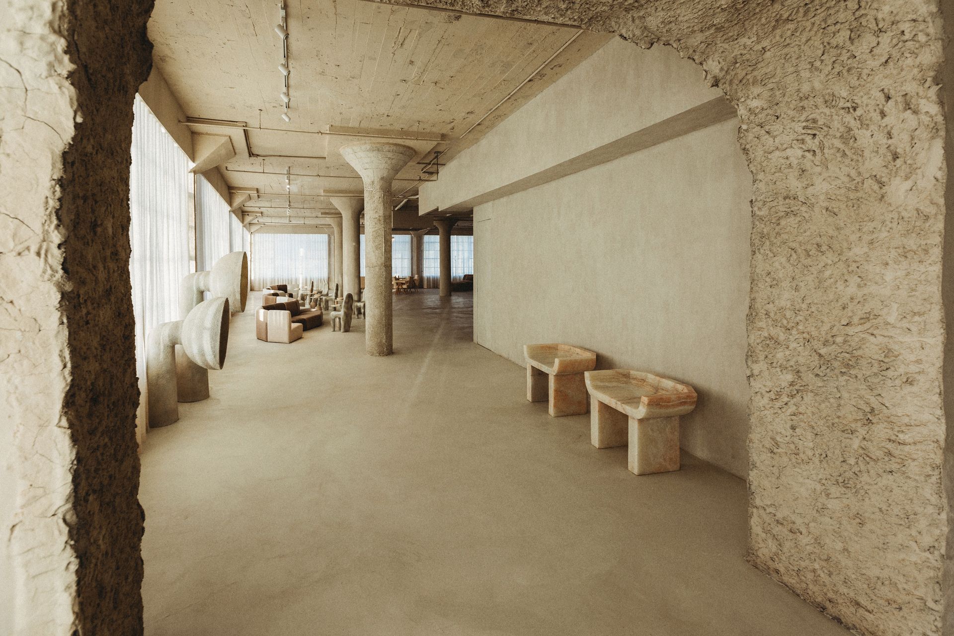 A long hallway with a few benches in it