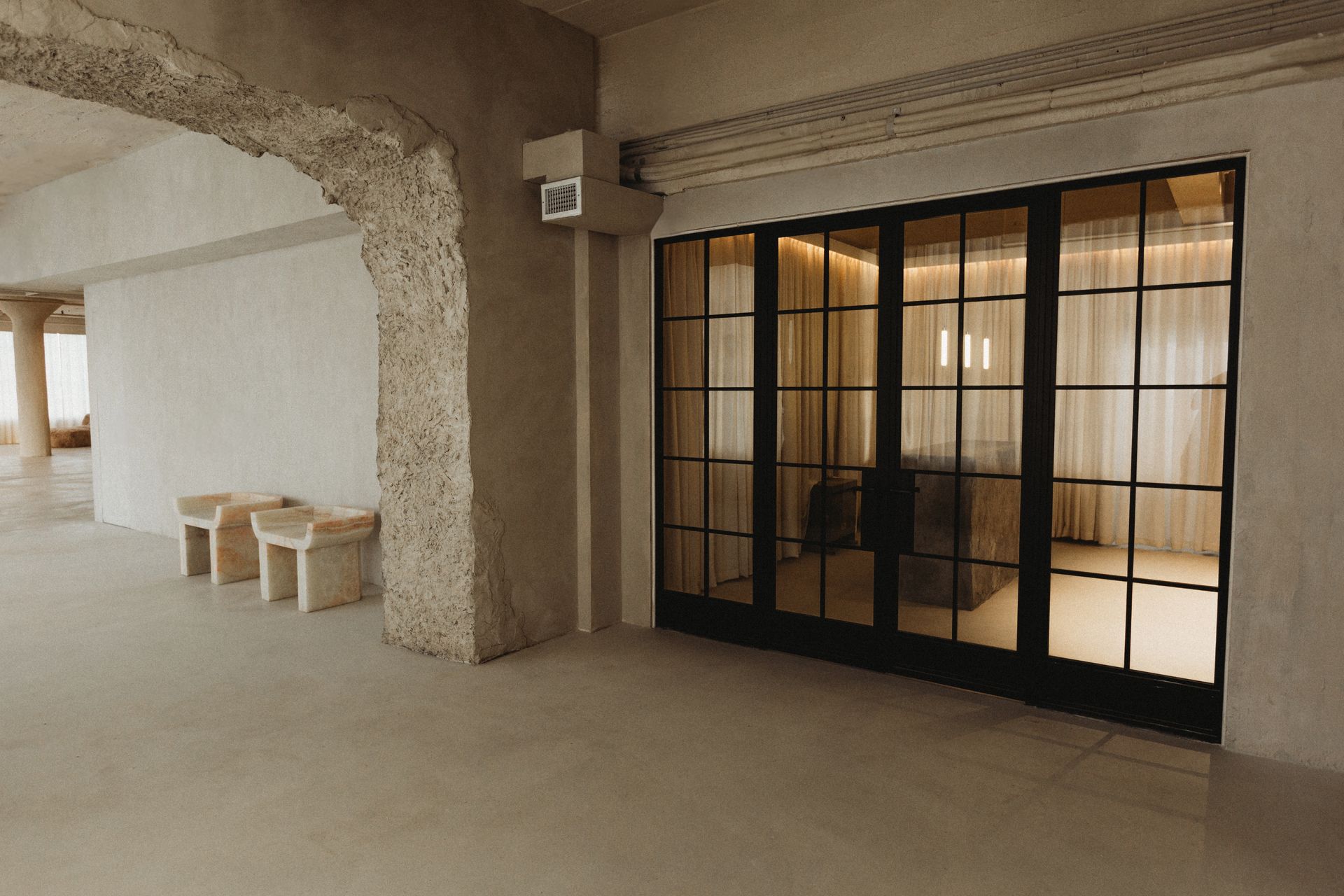 A room with a lot of windows and chairs in it