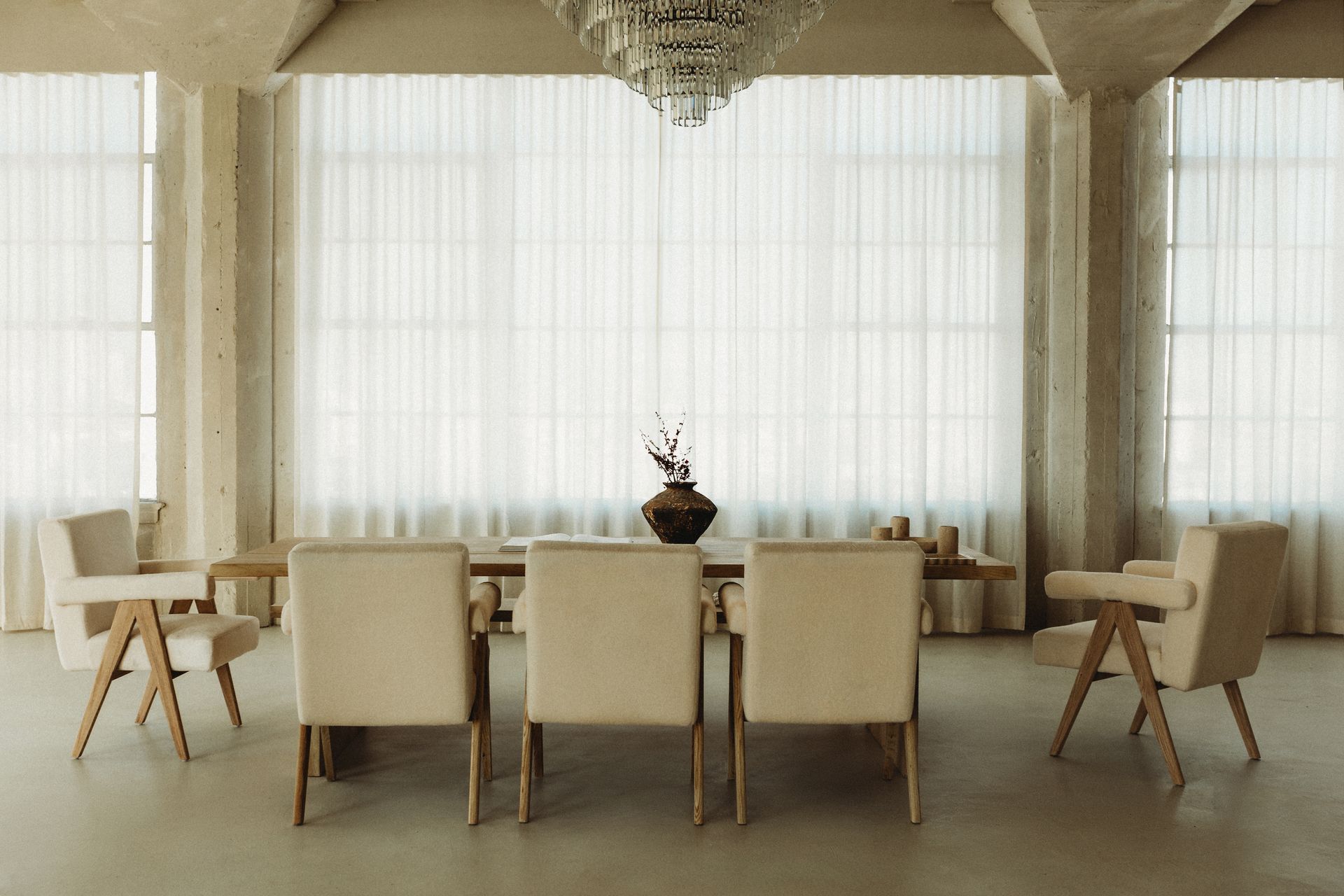 A dining room with a long table and chairs