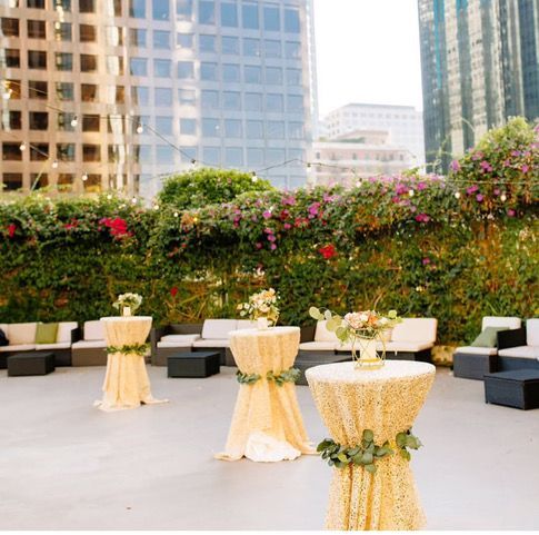 A patio with tables and chairs with flowers on them