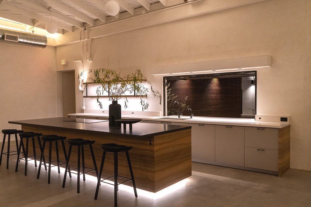 A kitchen with a large island and stools