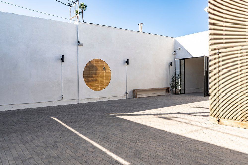 A white building with a circle in the middle of it