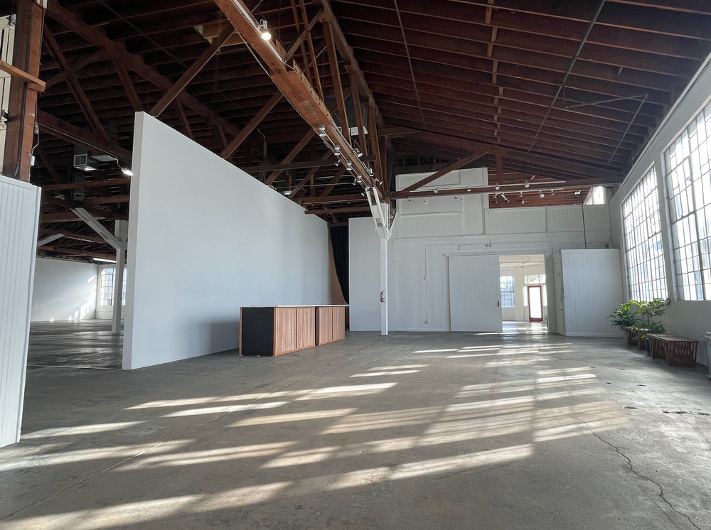 A large empty room with a wooden ceiling and white walls