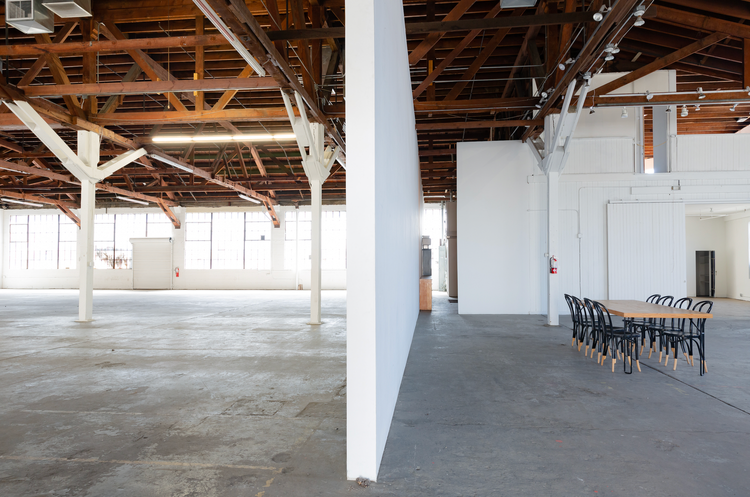 A large empty room with a table and chairs in it
