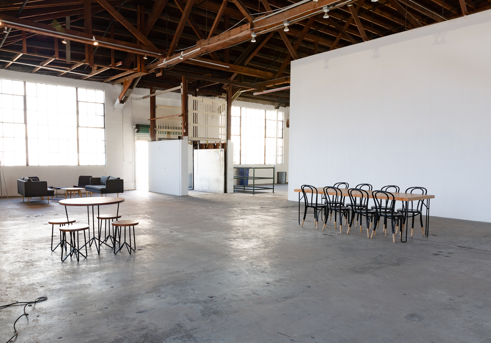 A large empty room with tables and chairs in it