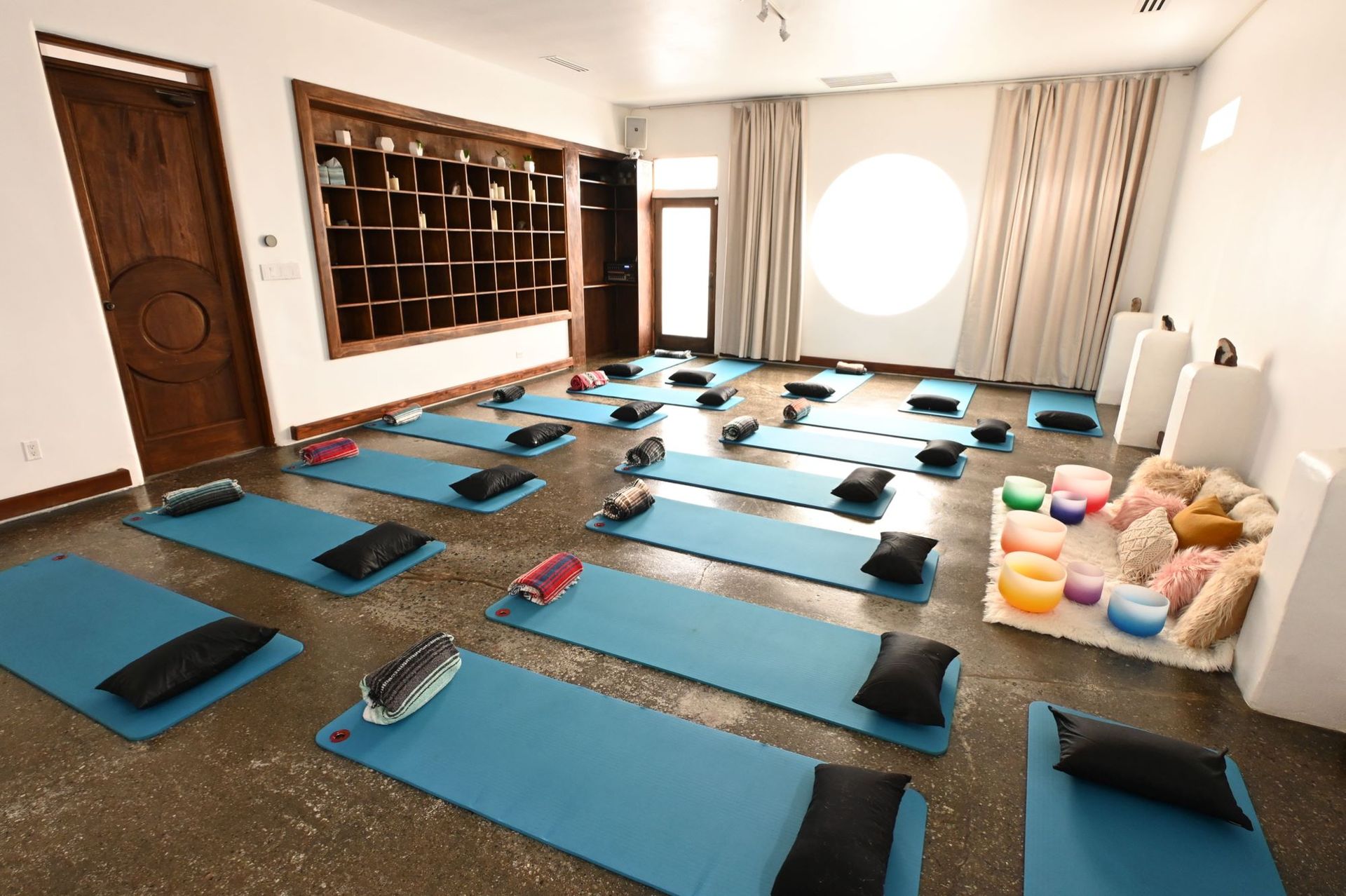 A room filled with blue yoga mats and pillows