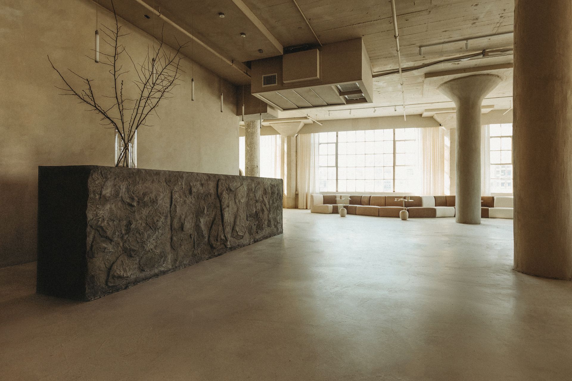 A large empty room with a stone counter in the middle