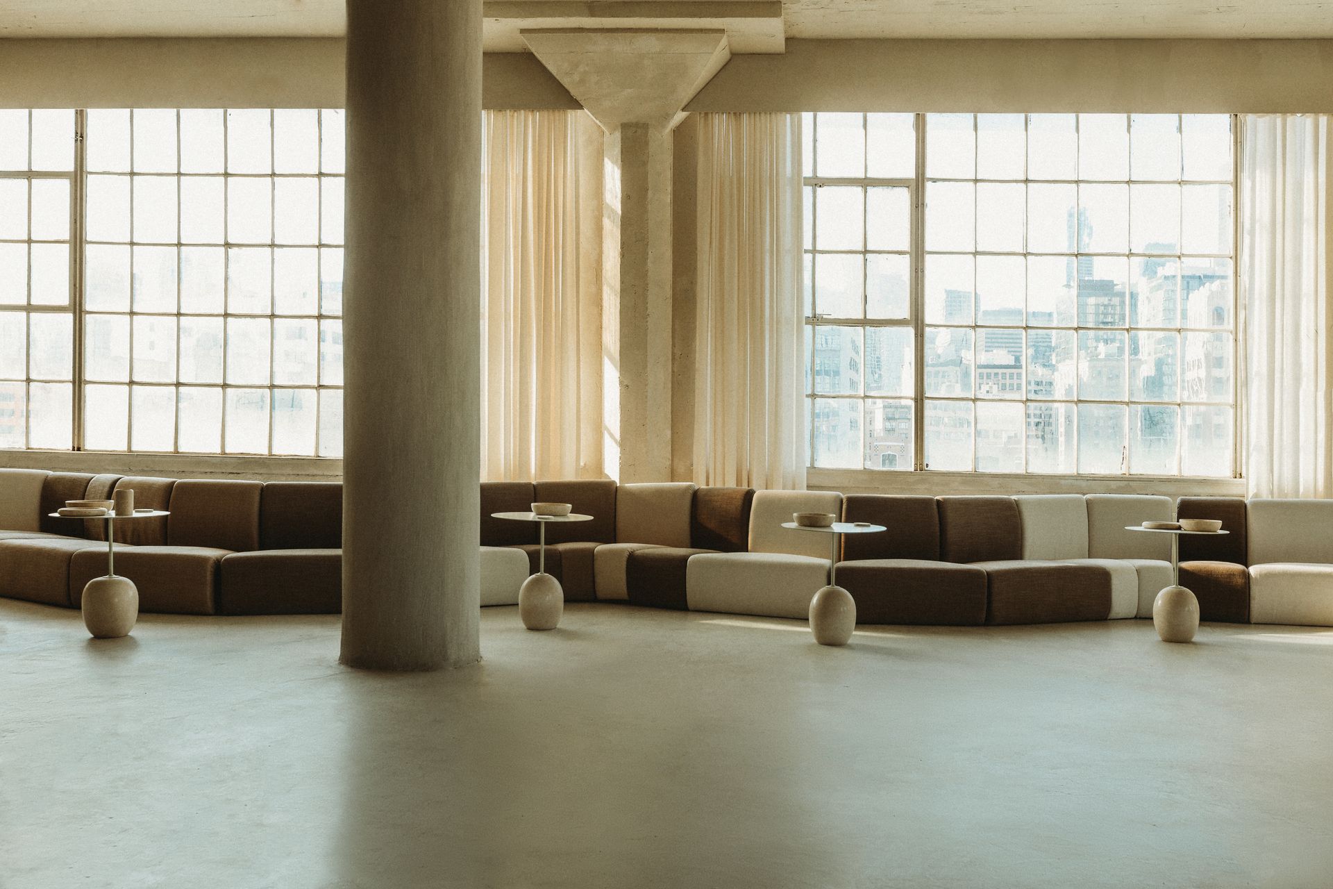 A large room with a lot of windows and furniture