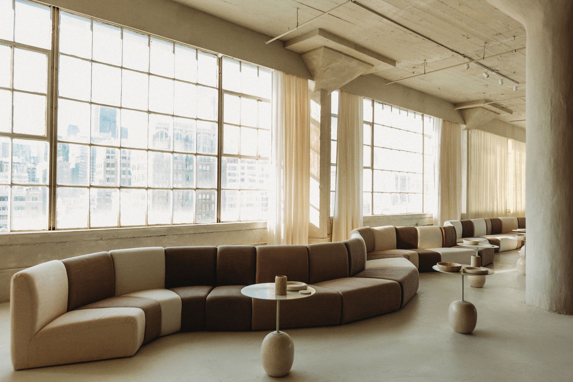 A large room with a couch and tables in it