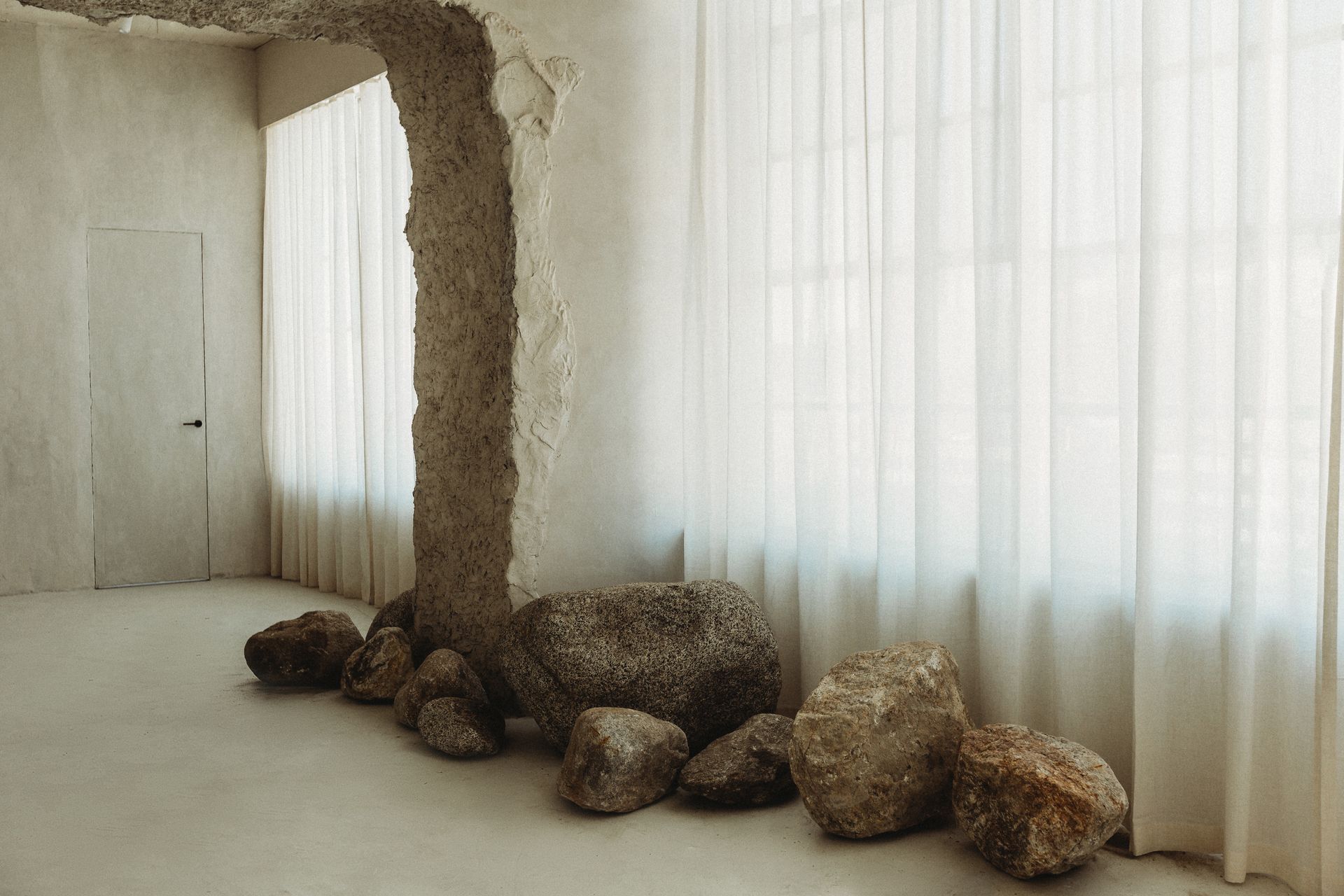 A room with a large rock in the middle of it.