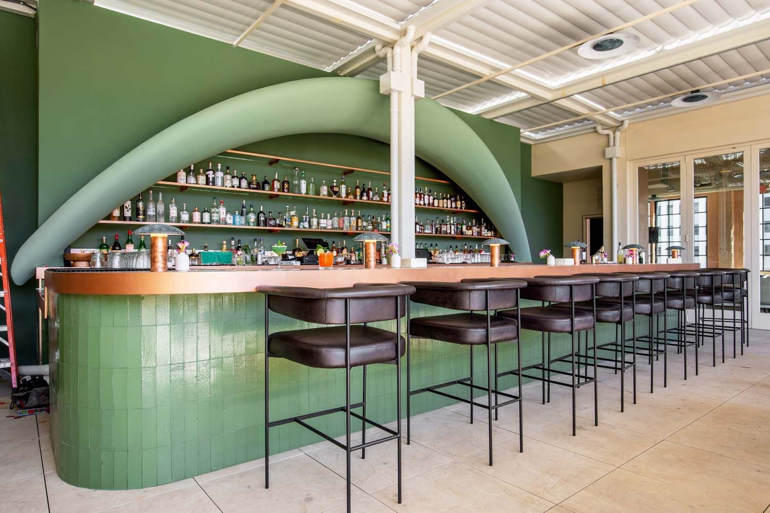 A restaurant with a long bar and stools