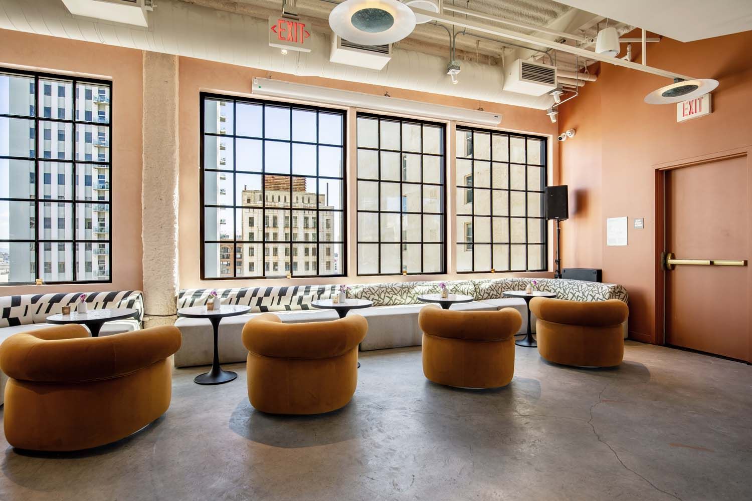 A room with a lot of windows and chairs and tables