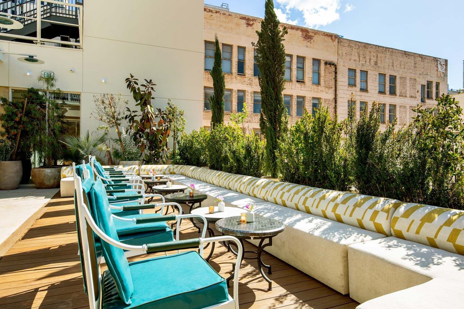A patio with tables and chairs in front of a building
