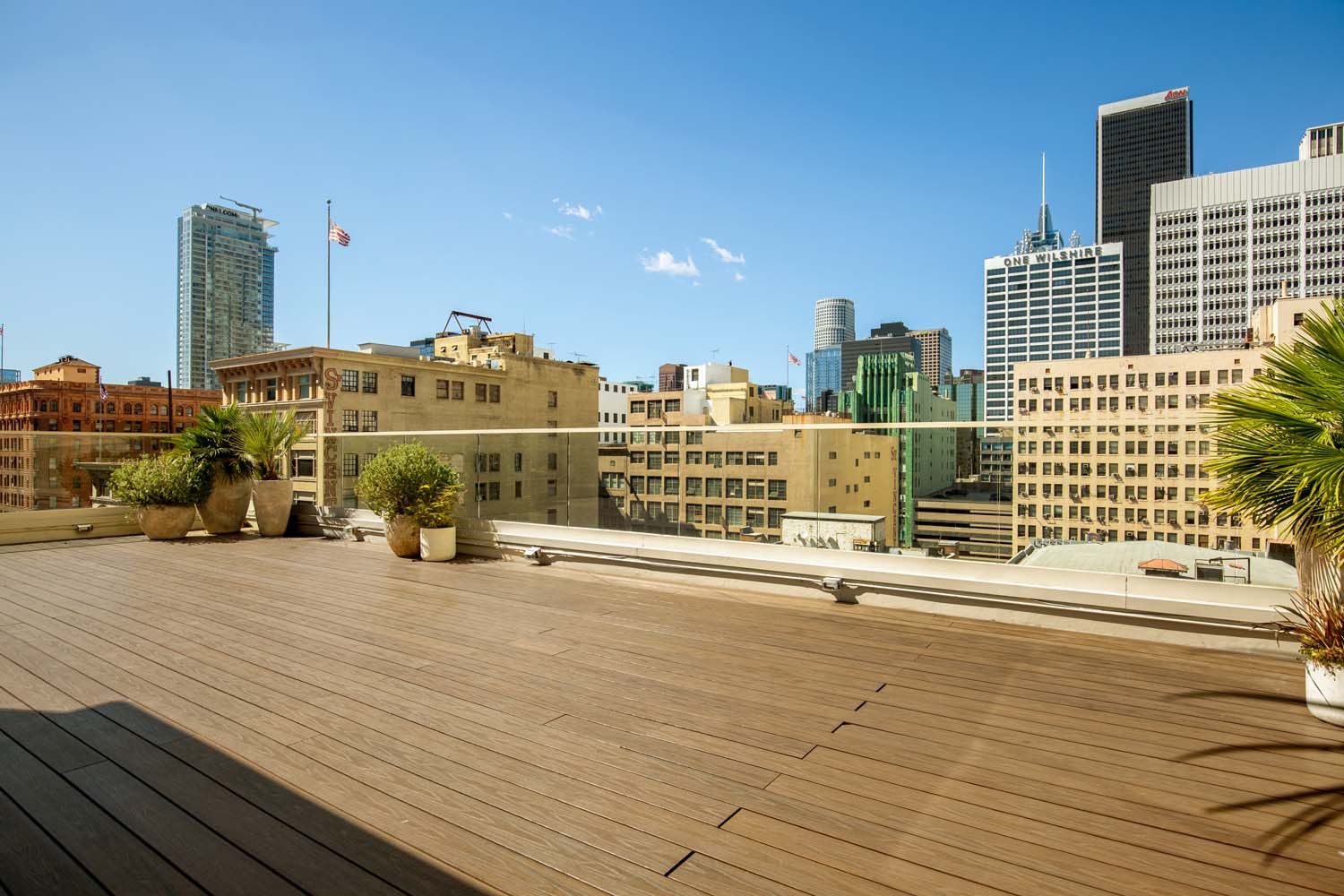 A rooftop deck with a view of a city skyline