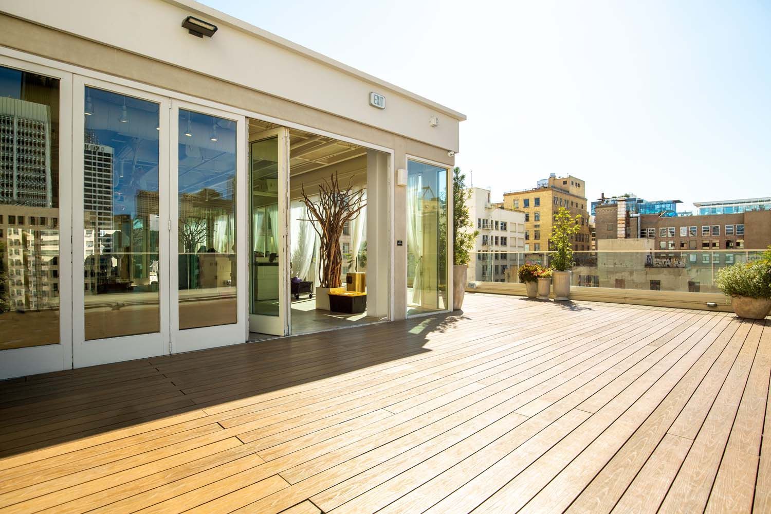 A large building with lots of windows and a wooden deck