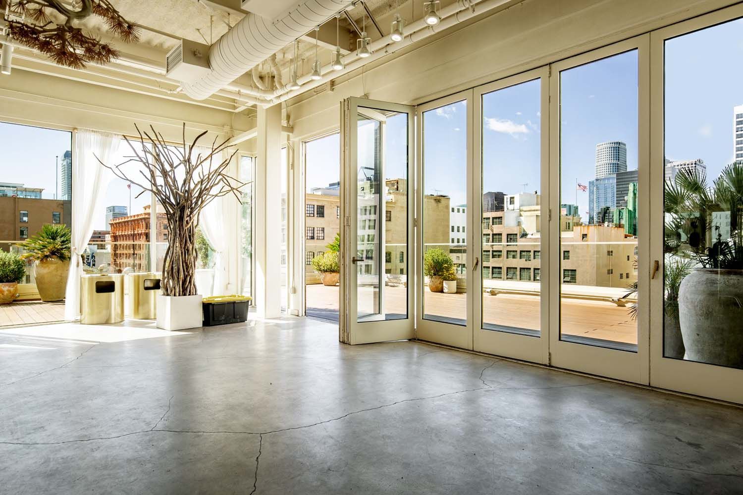 A large empty room with lots of windows and doors